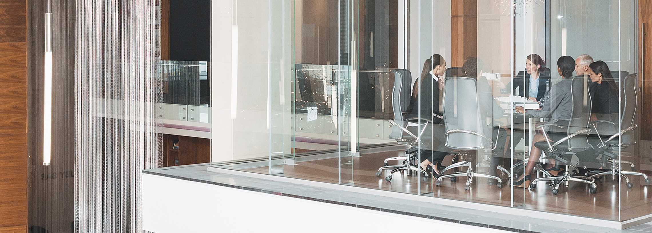 Glass meeting room in modern office.